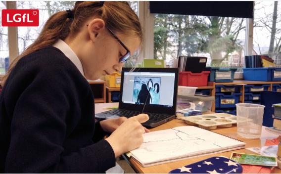 Image of child working at school with laptop